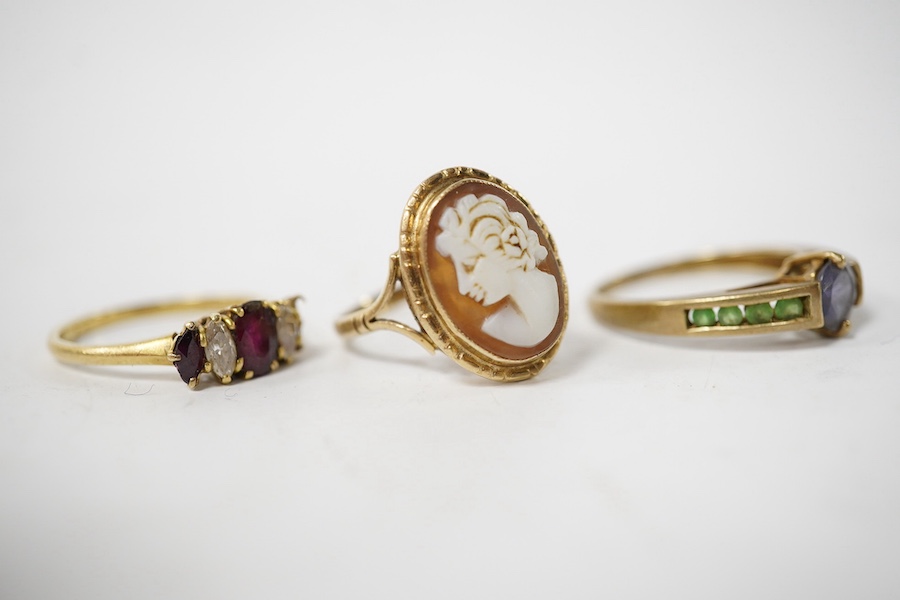 A late 1970's 18ct gold three stone ruby and two stone diamond set ring (one ruby missing), size N/O, gross weight 2.7 grams and two other 9ct gold and gem set rings including cameo shell, gross 5 grams. Condition - poor